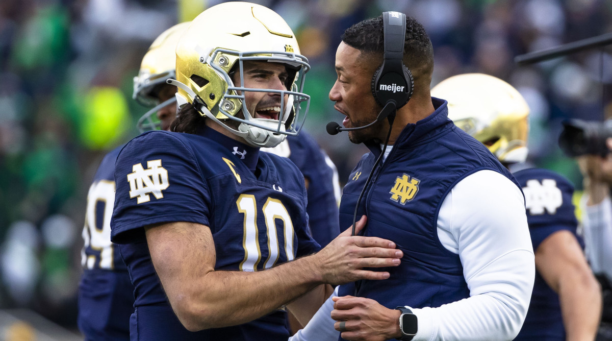 Notre Dame quarterback Sam Hartman celebrates with head coach Marcus Freeman during the Fighting Irish’s win over Pitt.